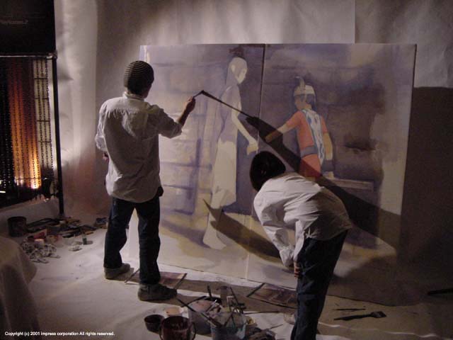 Image: Artists painting on two life sized canvases. One with e-koʊ, one with Yoruda, their hands meet where the canvases join.